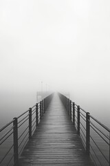 A black and white photo of a pier covered in fog. Perfect for capturing the mysterious and serene...