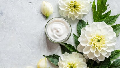 Obraz na płótnie Canvas spa concept or template florals compositions made white dahlia flowers and skincare cream vertical frame top view concept