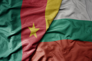 big waving national colorful flag of bulgaria and national flag of cameroon .