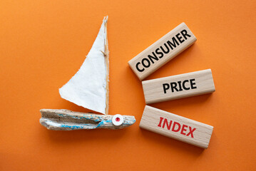 Consumer Price Index symbol. Concept words Consumer Price Index on wooden blocks. Beautiful orange...