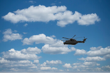 military helicopter flying in blue sky. High quality photo
