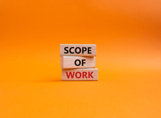 Scope of Work symbol. Concept words Scope of Work on wooden blocks. Beautiful orange background. Business and Scope of Work concept. Copy space.