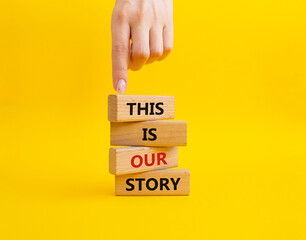 This is our Story symbol. Wooden blocks with words This is our Story. Businessman hand. Beautiful yellow background. Business and This is our Story concept. Copy space.
