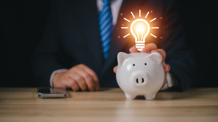 saving energy and money concept. idea for save or investment. businessman with lightbulb top of...