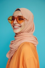 Fashion sunglasses, face or happy Muslim woman with hijab, designer brand glasses or casual outfit style. Gen z summer aesthetic, Islamic model smile and Arabic Islam female on blue background studio