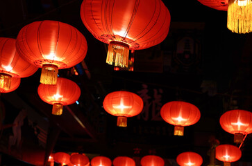 Chinese New Year red lamps symbolize luck, happiness, and ward off evil spirits, illuminating homes and streets with festive warmth
