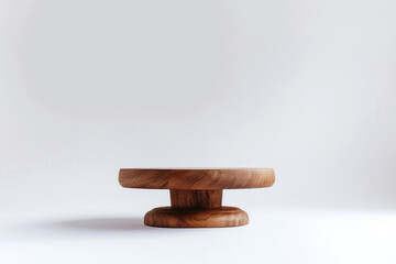 A wooden round table gracefully on a pristine white backdrop
