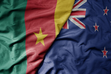 big waving national colorful flag of new zealand and national flag of cameroon .