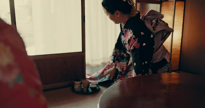 Japanese, ceremony and traditional woman with tea, service and tray with matcha or ginseng. Asian, culture and calm master in kimono with respect for hospitality, heritage and movement on floor