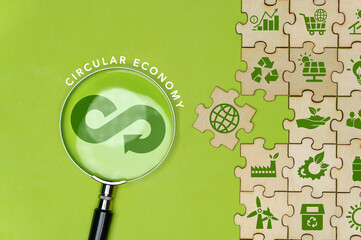 Circular economy icon on green background magnifying glass in circular economy concept for future...