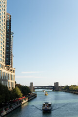 Riverwalk passes between the tall buildings in the city. Towers and water.