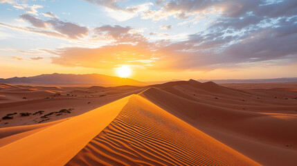Fototapeta na wymiar A desert landscape at sunset with long shadows and vibrant colors across the sand dunes.