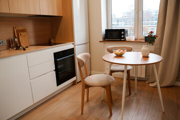 Chairs and table with salad, diet vegetable salad on the table , kitchen modern wooden interior
