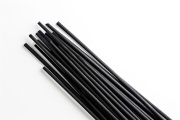 Black incense stick on white background viewed from above