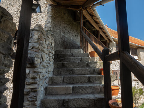 Narrow and steep stairs climbing an medieval wall and leading inside the gate tower of Calnic Fortress. A middle ages citadel built inside a rural area in Transylvania.