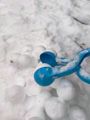 Snowballs on the heap and blue snowball maker