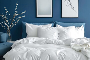 Blue bed with white pillows duvet and duvet case Blue sofa with white bed linen Bedroom with bed and bedding and poster frame mock up on wall Left side view - obrazy, fototapety, plakaty