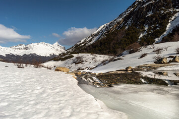Mountain range melting river, with snowy mountains in the background. Emerald Lagoon, Ushuaia