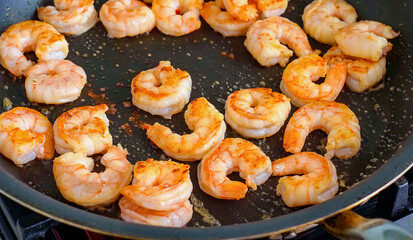 Shrimp with spices in frying pan. Homemade roasted shrimp, serving food for restaurant, menu, advert or package, close up, selective focus
