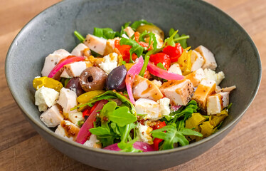 Healthy fresh meal with vegetables, chicken on plate. Homemade delicious lunch with chicken, bell pepper, olives, arugula for restaurant, menu, advert or package, close up selective focus