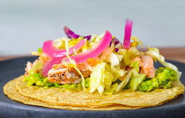 Healthy fresh meal, corn tortilla with salmon and vegetables on plate. Homemade delicious lunch for restaurant, menu, advert or package, close up selective focus. - 723253911