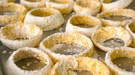 Onion rings fresh sliced. Homemade onion rings preparation for frying, food or burger ingredient for restaurant, menu, advert or package, close up selective focus. - 723253983