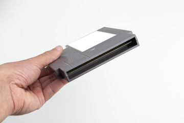 hand holds game cartridge with blank label