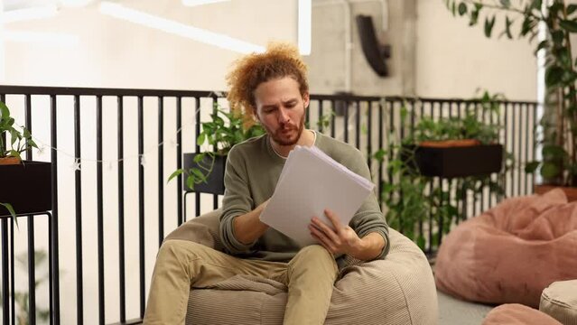 a young adult to check that all the documents are correct puts on his glasses while happily affirming