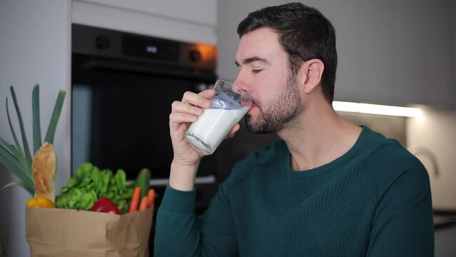 Handsome man drinking some milk 