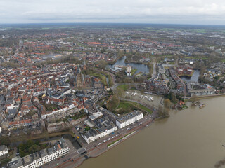 Obraz premium Aerial overview of the city of Zutphen, along the river Ijssel in Gelderland, The Netherlands. Birds eye aerial drone view in the Dutch province of Gelderland.