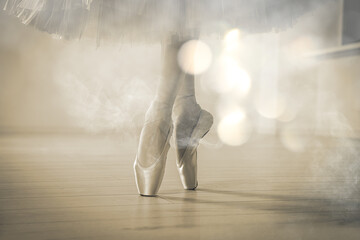 Perfection in ballet. Woman dancing in pointe shoes in studio, closeup. Bokeh effect with smoke - obrazy, fototapety, plakaty