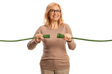 Happy mature woman plugging in green electric cables
