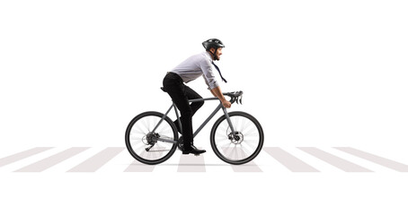 Profile shot of a businessman riding a bicycle at a pedestrian crossing