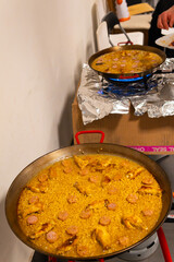 cooking two Spanish paellas over gas fires in a Spanish home. culinary tradition