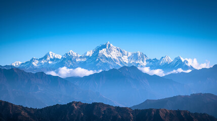 A majestic mountain range with snow-capped peaks under a clear blue sky.