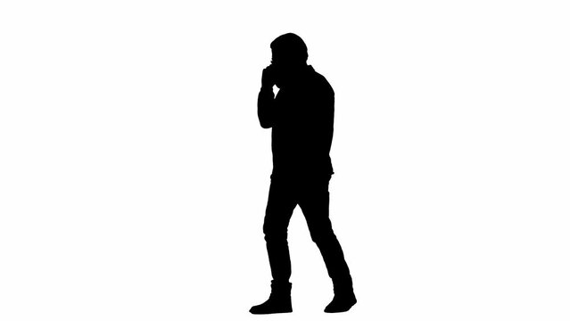 Black silhouette of elderly bearded man on white isolated background. Full frame elderly man walking, talking on cell phone and gesturing with hand. Half turn.