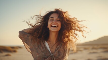 A brunette latina woman raising her arms in happiness on the dunes with her back to the sea - obrazy, fototapety, plakaty