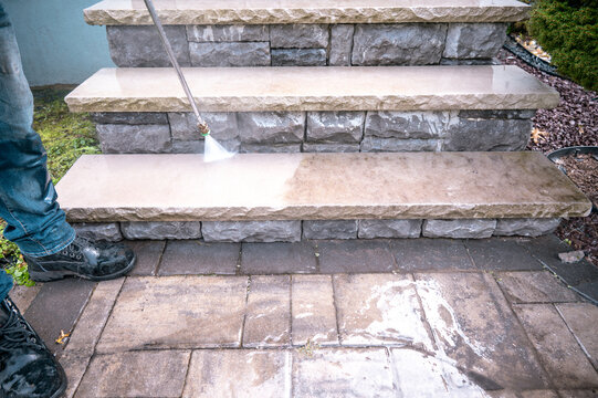 pressure water jet during cleaning dirty outdoor porch stairs with copy-space