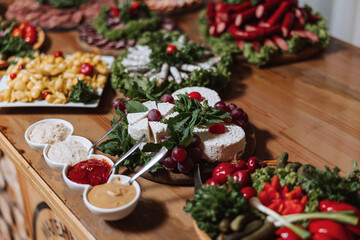 Meat and cheese snacks on the buffet. A buffet in a closed room, at a wedding celebration or birthday. Sandwiches on skewers before the start of the holiday.
