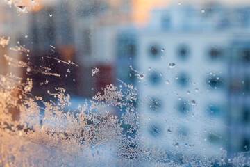 View of multi-storey residential buildings through a frosty window