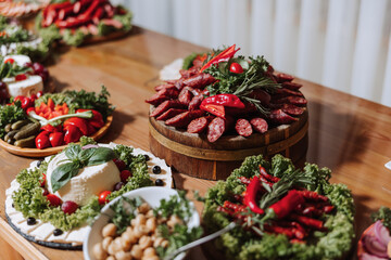 Meat and cheese snacks on the buffet. A buffet in a closed room, at a wedding celebration or birthday. Sandwiches on skewers before the start of the holiday.