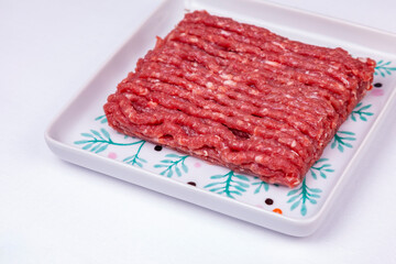 Raw minced beef on a rectangular plate - 723297788