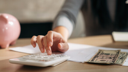 Close up hand of Business woman using laptop while plan and discussion information for financial in home office. Beautiful woman happy and working at indoors.