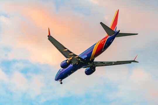 Southwest Airlines Boeing flies in the sunset sky. 