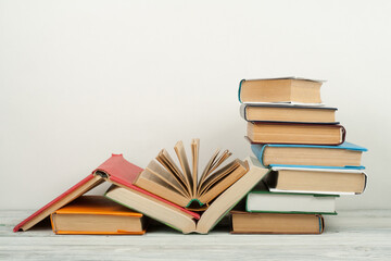 Open book, hardback colorful books on wooden table. Back to school. Copy space for text. Education business concept.