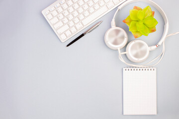 Tablet, calculator, phone, pen and a cup of coffee, lot of things on a light background. Top view with copy space.