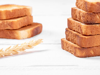 Golden brown toasted white bread slices on clean white table setting