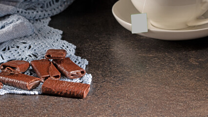 Evening tea setting with chocolate treats and a hot cup of tea ready to be enjoyed