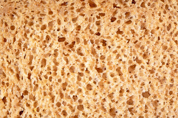 Detailed close-up view of sliced bread texture, freshly baked wheat loaf surface