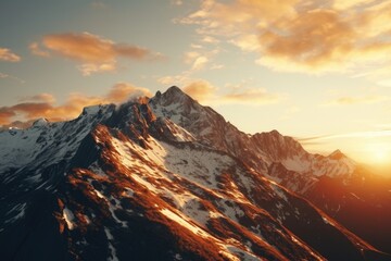 Sun setting over a snowy mountain, perfect for winter landscapes and nature photography